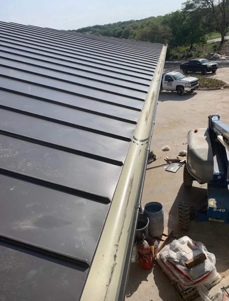 Standing seam panel and gutter detail on a metal roofing jobsite in Mount Vernon